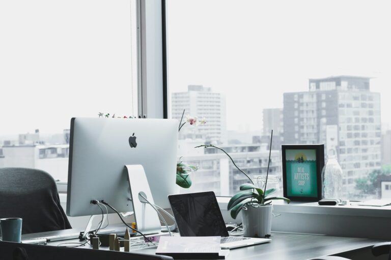 Modern office workstation with monitor and city view symbolizing TMC automation